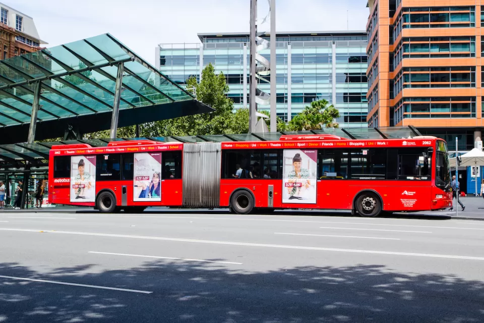 Red articulated public transit bus in Sydney, Australia.